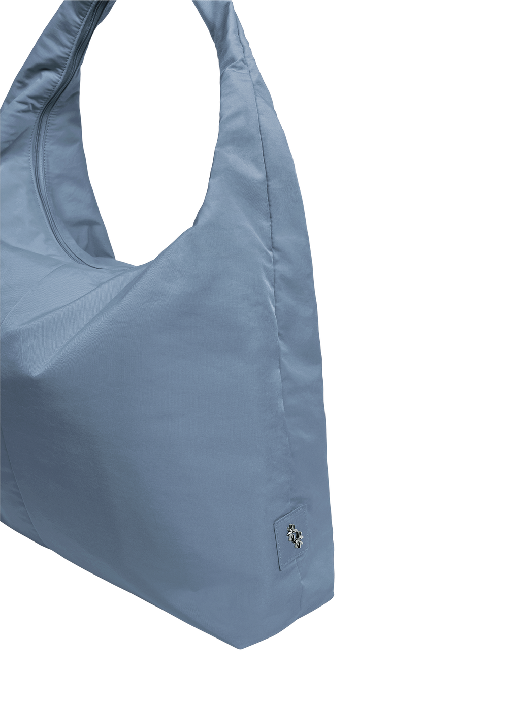 Close-up of the Arc hobo-style bag in grey blue nylon, showing metal logo emblem