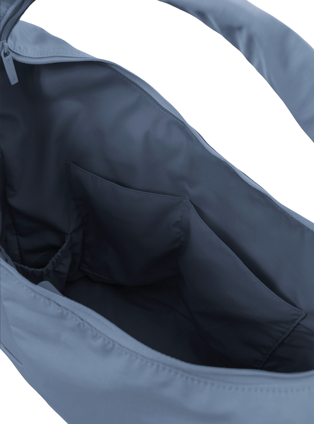 Interior of the Arc hobo-style bag in grey blue nylon, with multiple pockets and a bottle holder
