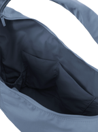 Interior of the Arc hobo-style bag in grey blue nylon, with multiple pockets and a bottle holder