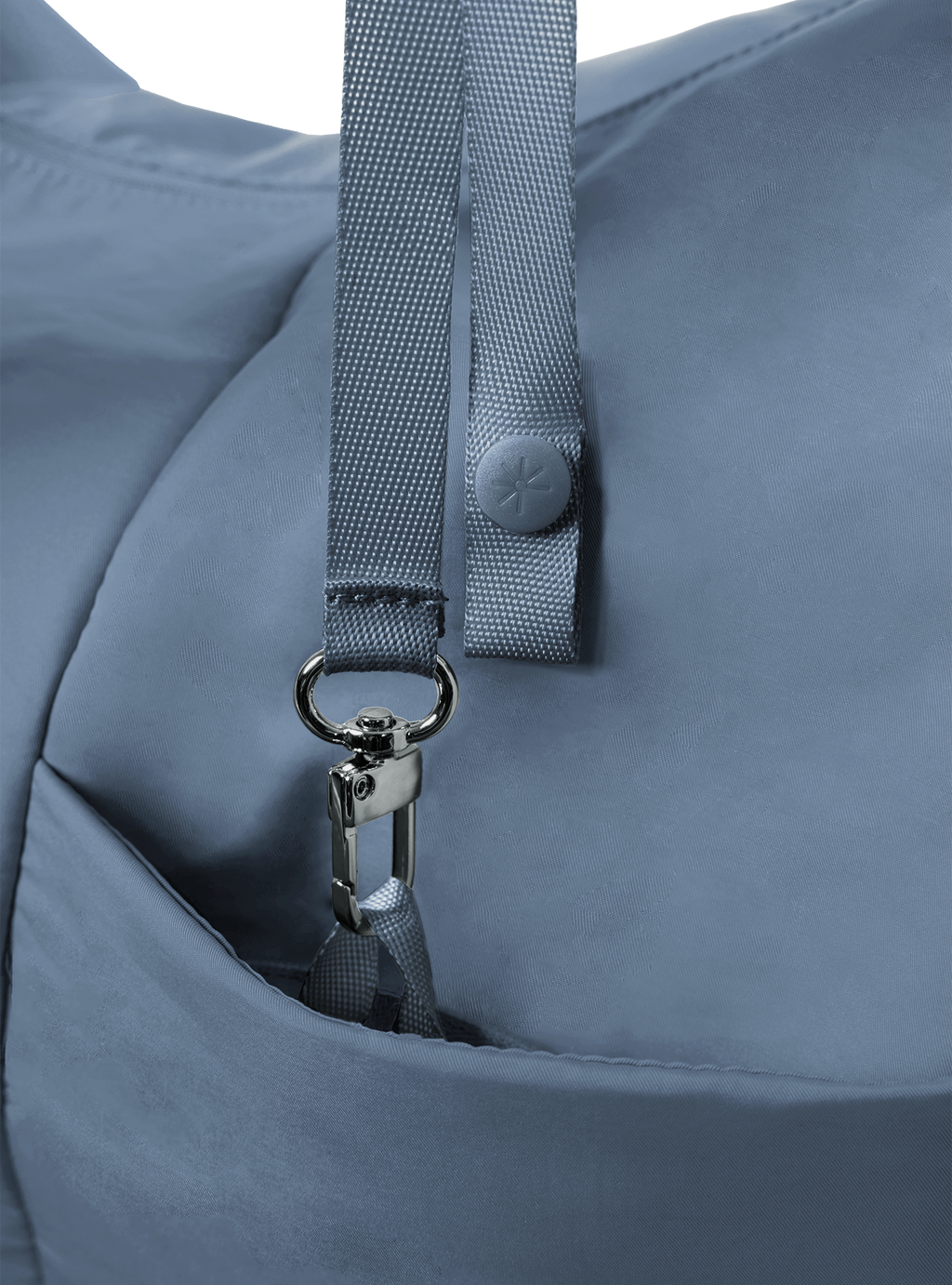 Exterior pocket of the Arc hobo-style bag in grey blue nylon, with concealed snap loop