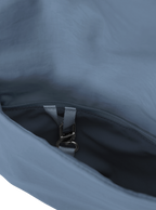 Exterior pocket of the Arc hobo-style bag in grey blue nylon, with concealed snap loop