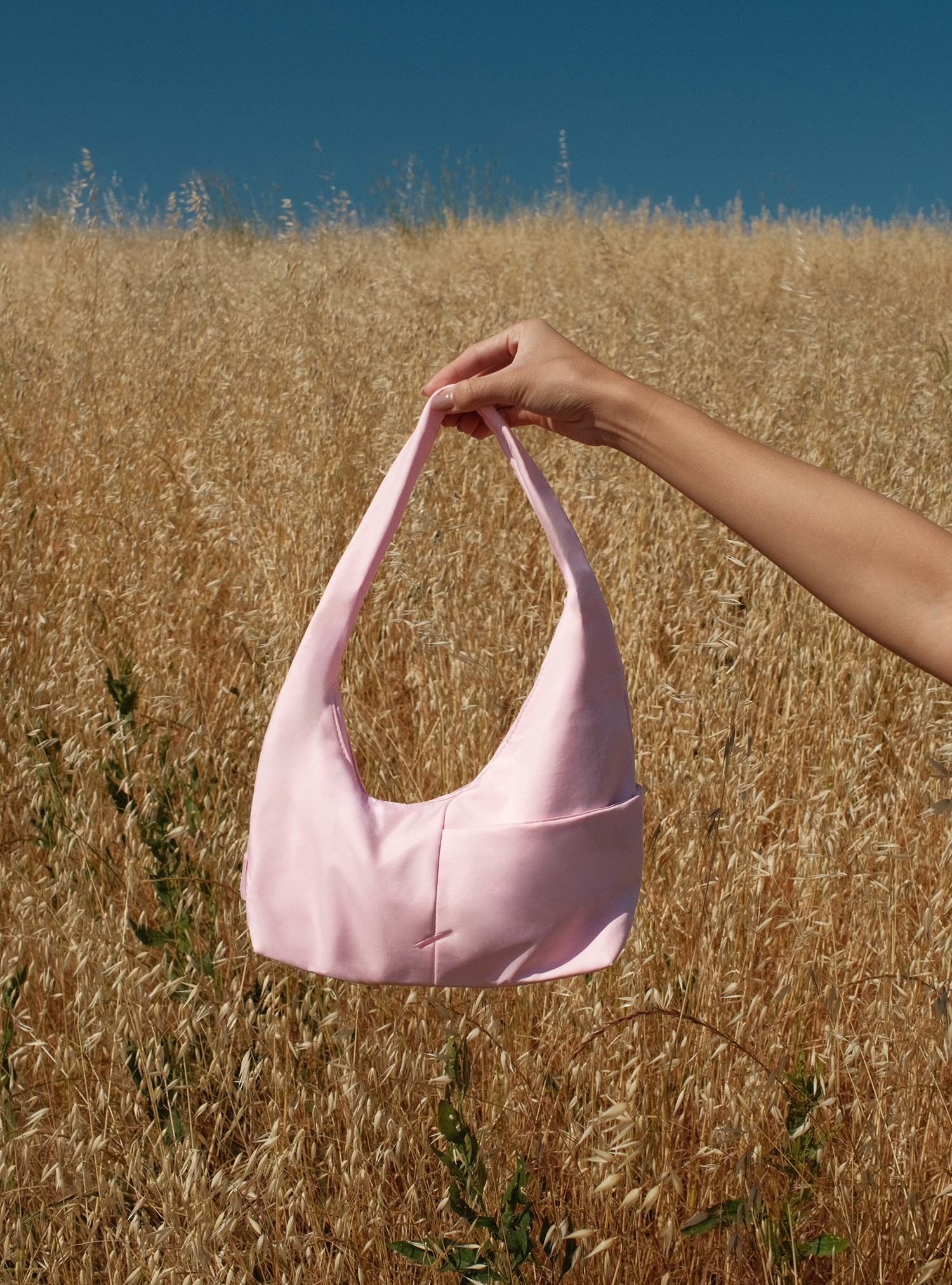 The Mini Arc slouchy hobo-style shoulder bag in light pink nylon for errands, weekends and everyday use