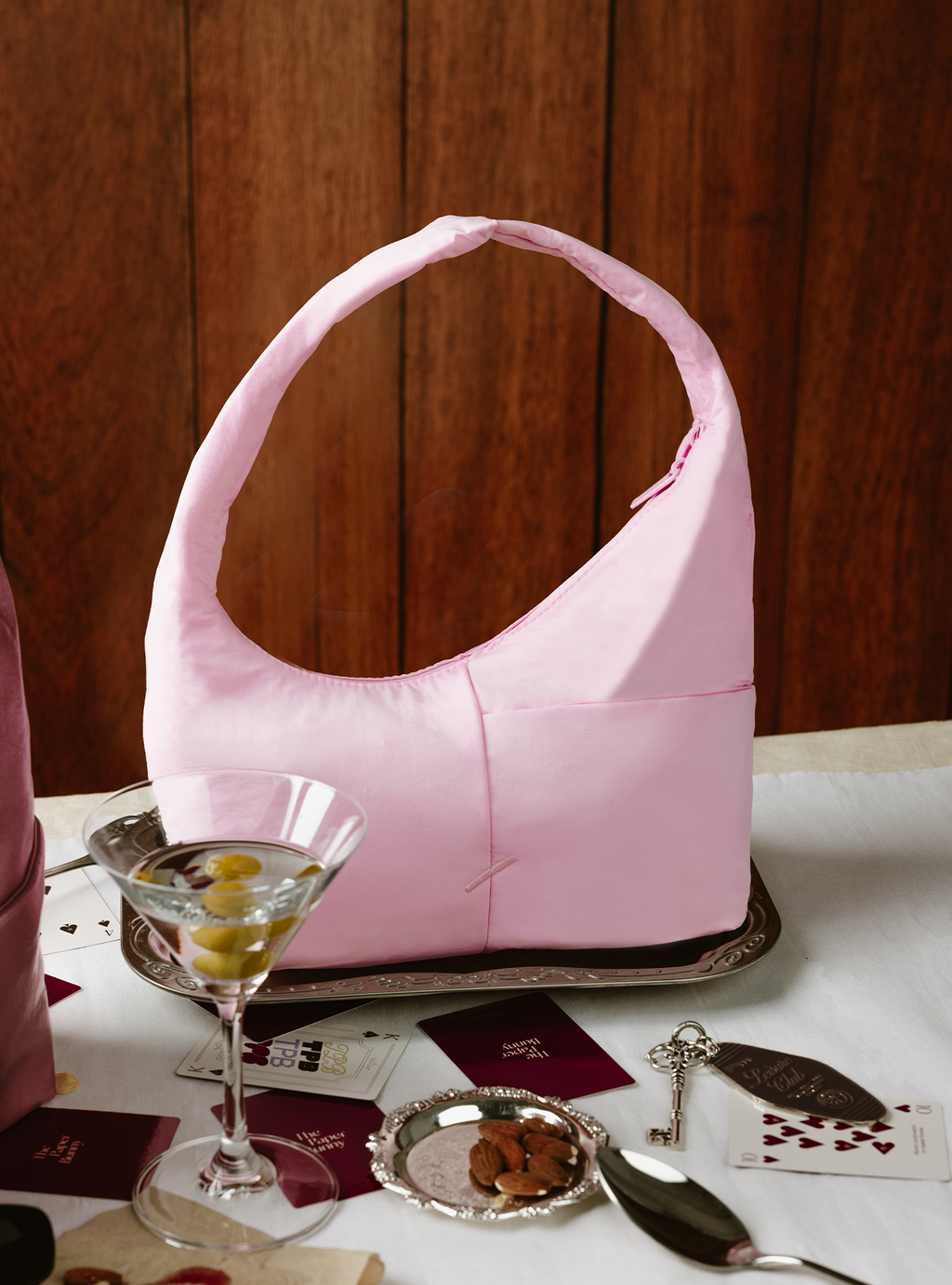 The Mini Arc slouchy hobo-style shoulder bag in light pink nylon for errands, weekends and everyday use