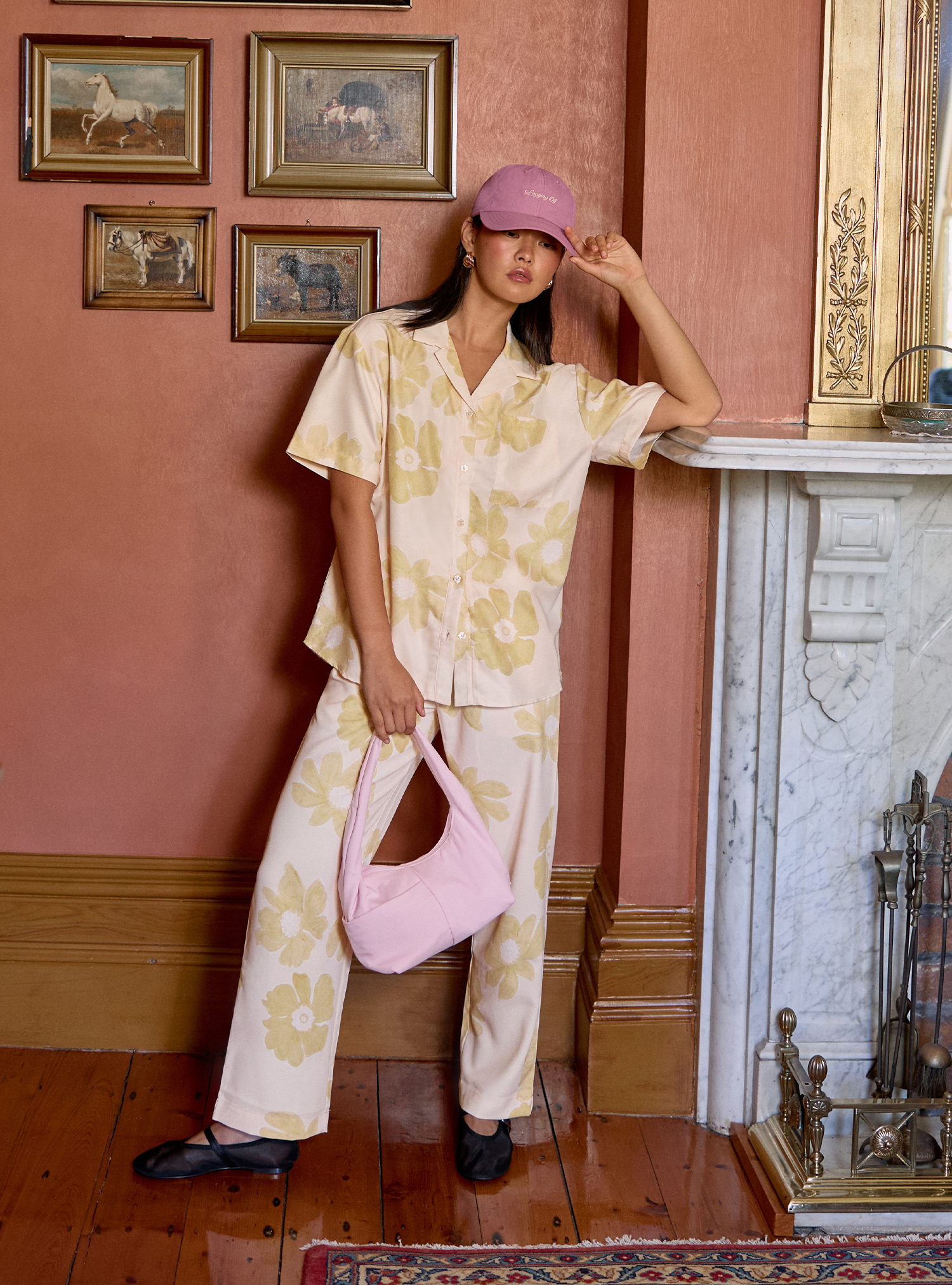 Woman holding the Mini Arc slouchy hobo shoulder bag in light pink nylon