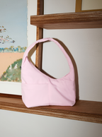 The Mini Arc slouchy hobo-style shoulder bag in water-resistant light pink nylon for errands, weekends and everyday use