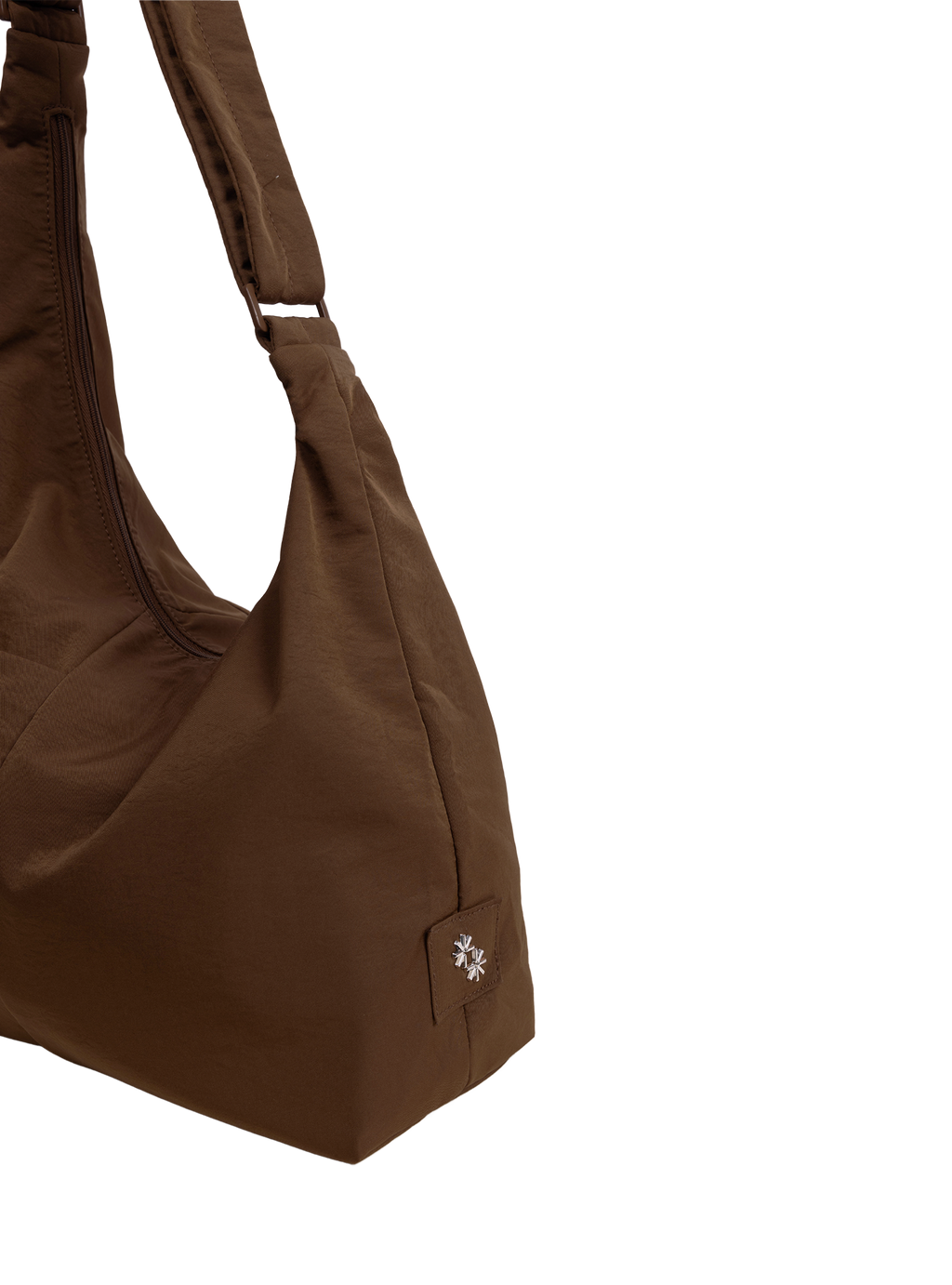 Close-up of the Midi Arc hobo-style bag in chocolate brown nylon, showing metal logo emblem