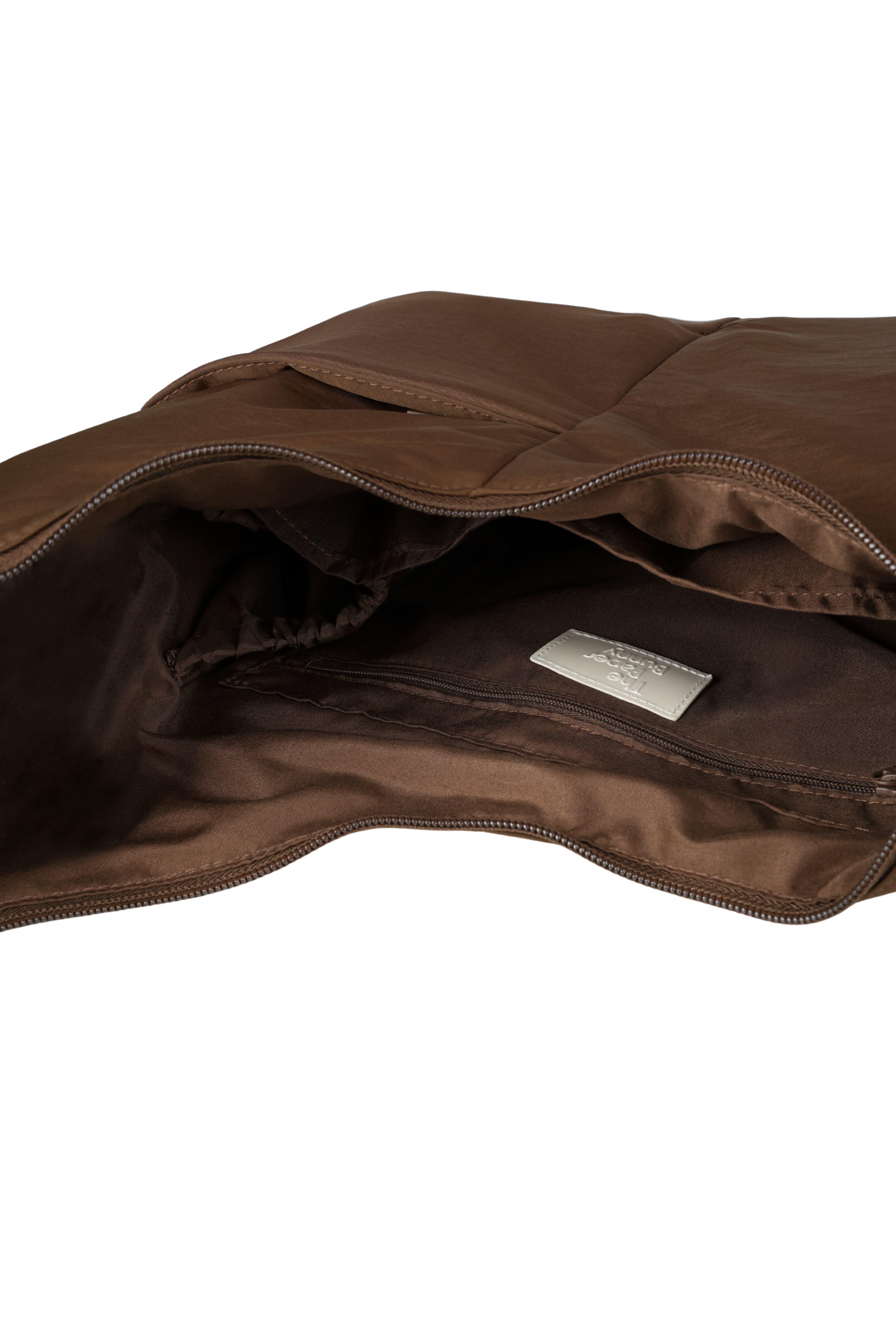 Interior of the Midi Arc hobo-style bag in chocolate brown nylon, with multiple pockets and a bottle holder
