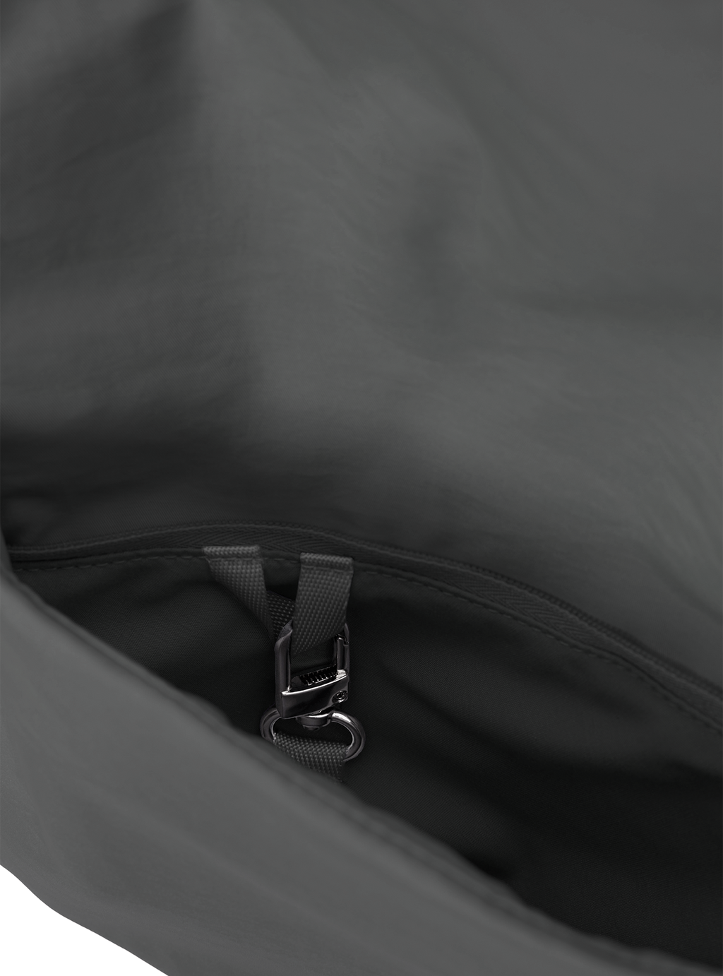 Exterior pocket of the Midi Arc hobo-style bag in dark grey nylon, with concealed snap loop