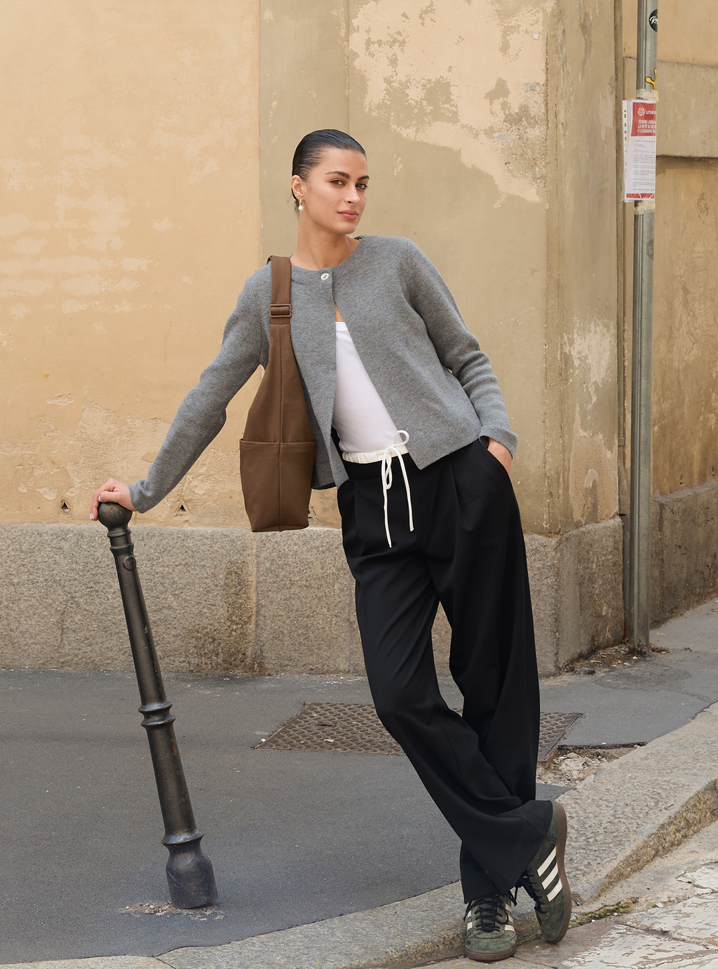 Woman carrying the Midi Arc slouchy hobo bag in chocolate brown nylon as shoulder bag