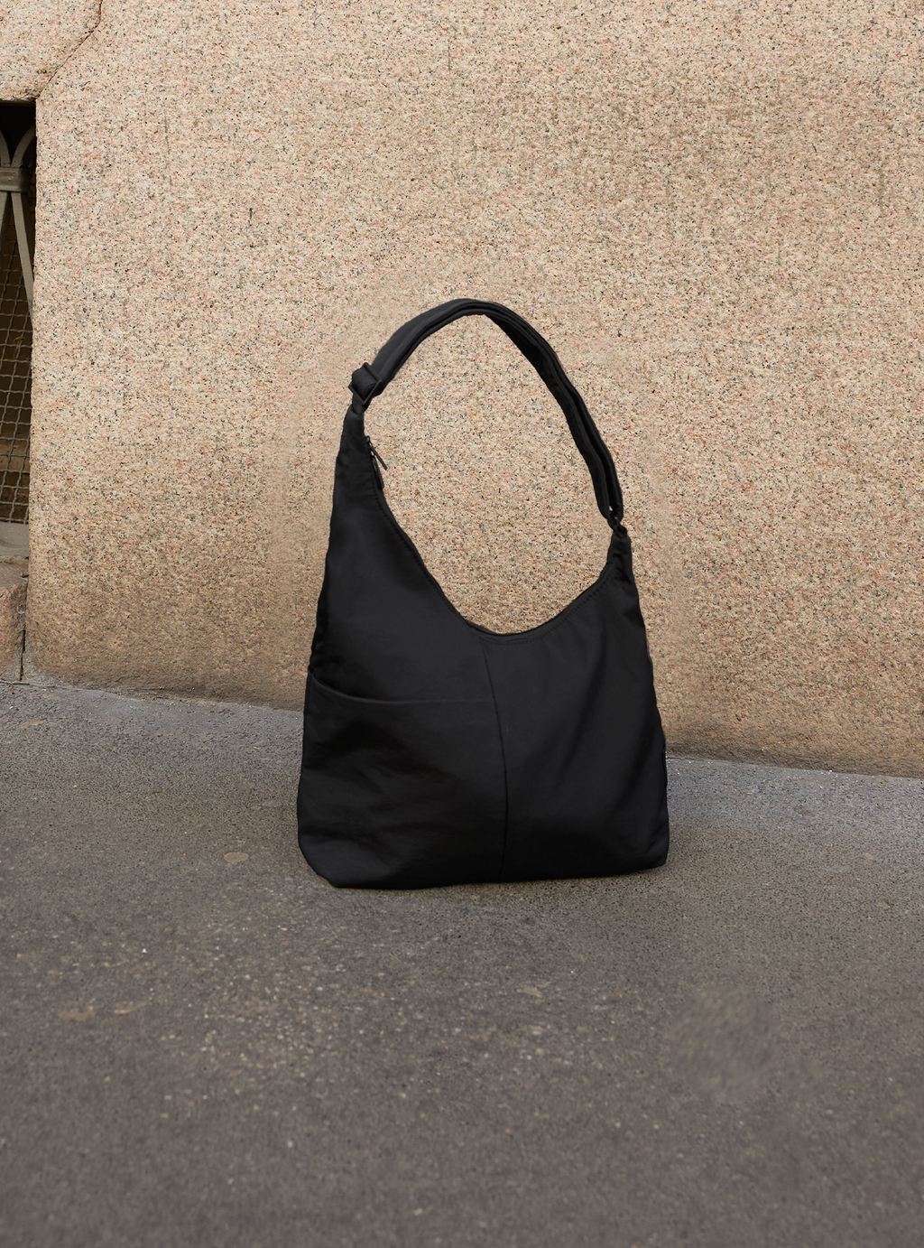 The Midi Arc slouchy hobo bag in black nylon for work, travel and everyday use