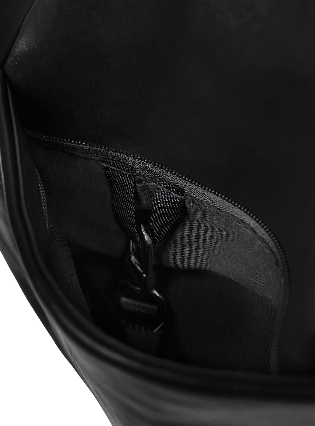 Exterior pocket of the Midi Arc hobo-style bag in matte black vegan leather, with concealed snap loop