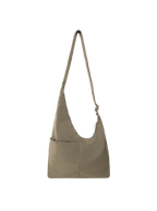The Midi Arc slouchy hobo bag in beige nylon with adjustable strap for shoulder or crossbody wear