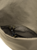Exterior pocket of the Midi Arc hobo-style bag in beige nylon, with concealed snap loop