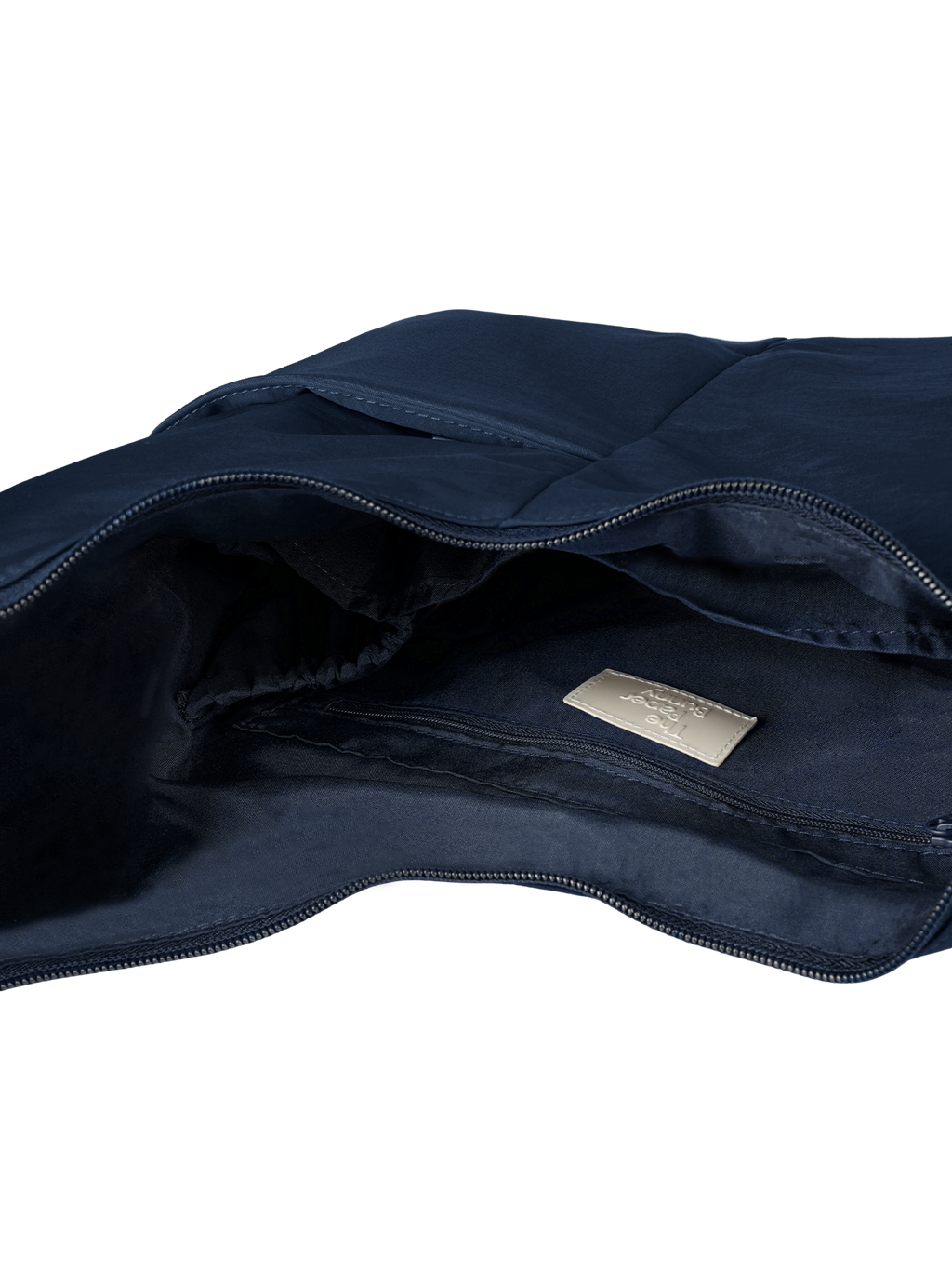 Interior of the Midi Arc hobo-style bag in navy nylon, with multiple pockets and a bottle holder