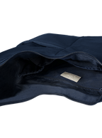 Interior of the Midi Arc hobo-style bag in navy nylon, with multiple pockets and a bottle holder