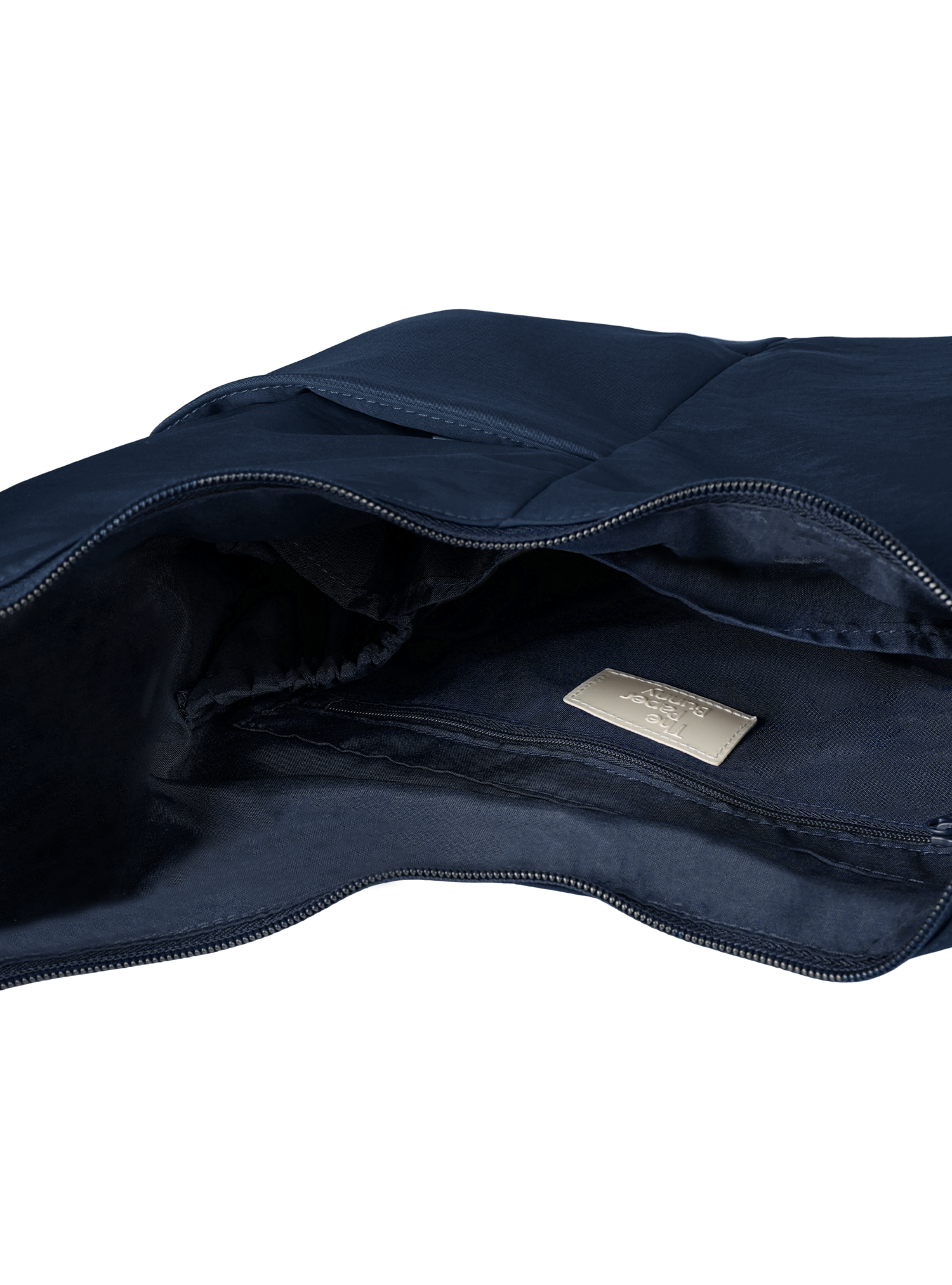 Interior of the Midi Arc hobo-style bag in navy nylon, with multiple pockets and a bottle holder