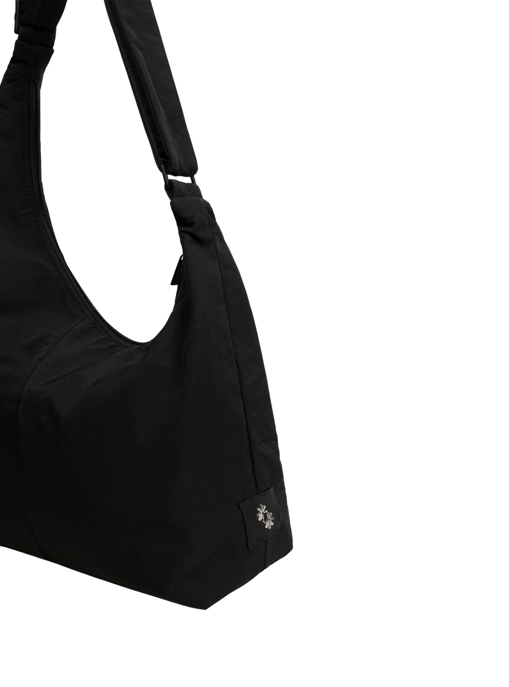Close-up of the Midi Arc hobo-style bag in black nylon, showing metal logo emblem