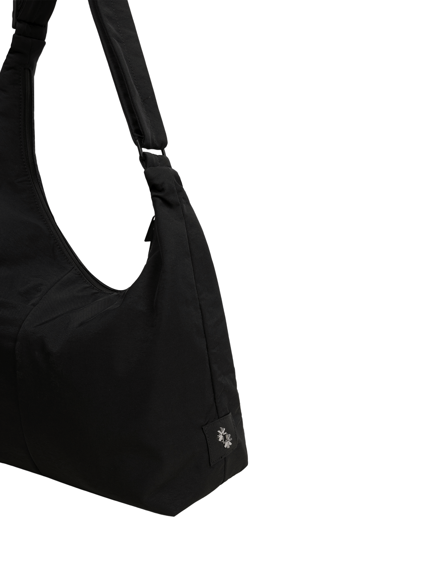 Close-up of the Midi Arc hobo-style bag in black nylon, showing metal logo emblem
