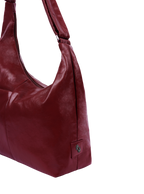 The Midi Arc slouchy hobo-style bag in wine red vegan leather with adjustable shoulder strap