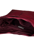 Interior of the Midi Arc hobo-style bag in wine red vegan leather, with multiple pockets and a bottle holder