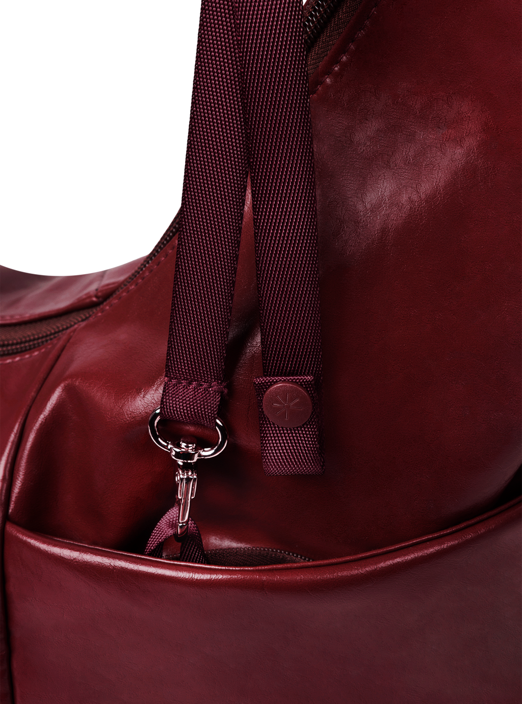 Exterior pocket of the Midi Arc hobo-style bag in wine red vegan leather, with concealed snap loop