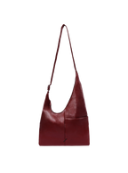 The Midi Arc slouchy hobo bag in wine red vegan leather with adjustable strap for shoulder or crossbody wear