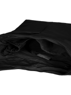 Interior of the Midi Arc hobo-style bag in black vegan leather, with multiple pockets and a bottle holder