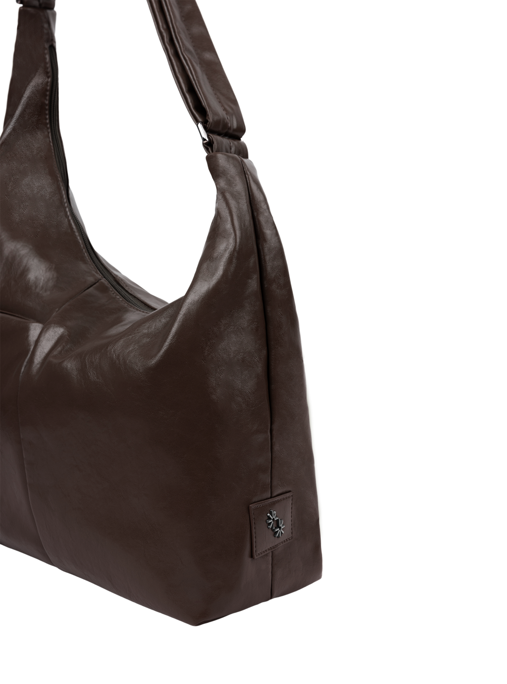 Close-up of the Midi Arc hobo-style bag in dark brown vegan leather, showing metal logo emblem