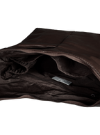Interior of the Midi Arc hobo-style bag in dark brown vegan leather, with multiple pockets and a bottle holder