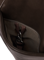 Exterior pocket of the Midi Arc hobo-style bag in dark brown vegan leather, with concealed snap loop