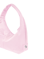 Close-up of the Mini Arc hobo-style shoulder bag in light pink nylon, showing metal logo emblem