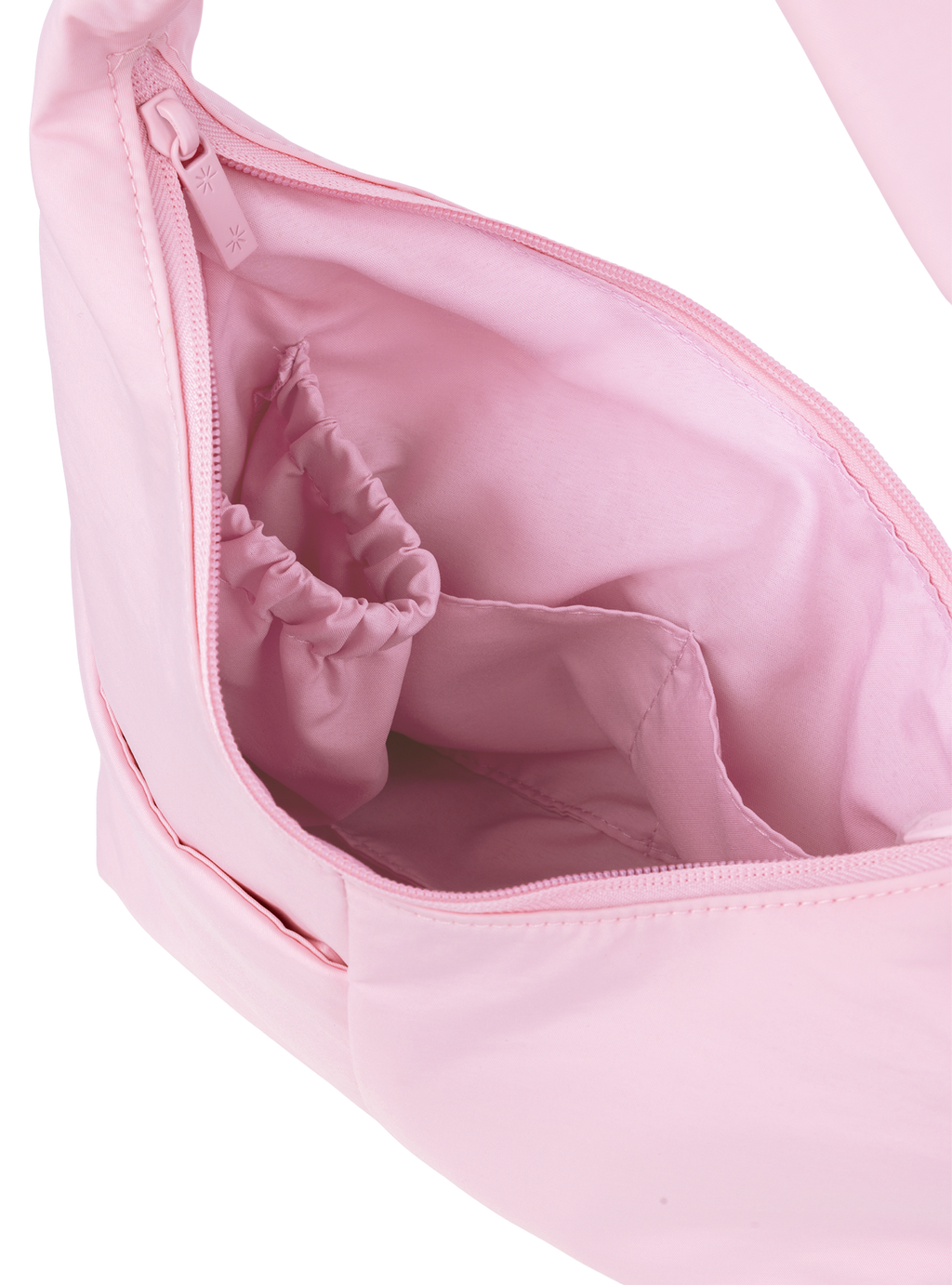 Interior of the Mini Arc hobo-style shoulder bag in light pink nylon, with multiple pockets and a bottle holder