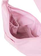 Interior of the Mini Arc hobo-style shoulder bag in light pink nylon, with multiple pockets and a bottle holder