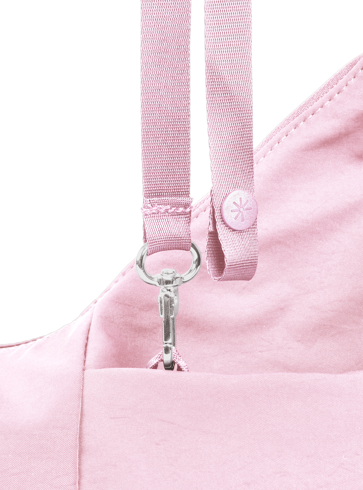 Exterior pocket of the Mini Arc hobo-style shoulder bag in light pink nylon, with concealed snap loop