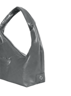 Close-up of the Mini Arc hobo-style shoulder bag in deep grey vegan leather, showing metal logo emblem