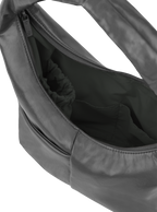 Interior of the Mini Arc hobo-style shoulder bag in deep grey vegan leather, with multiple pockets and a bottle holder