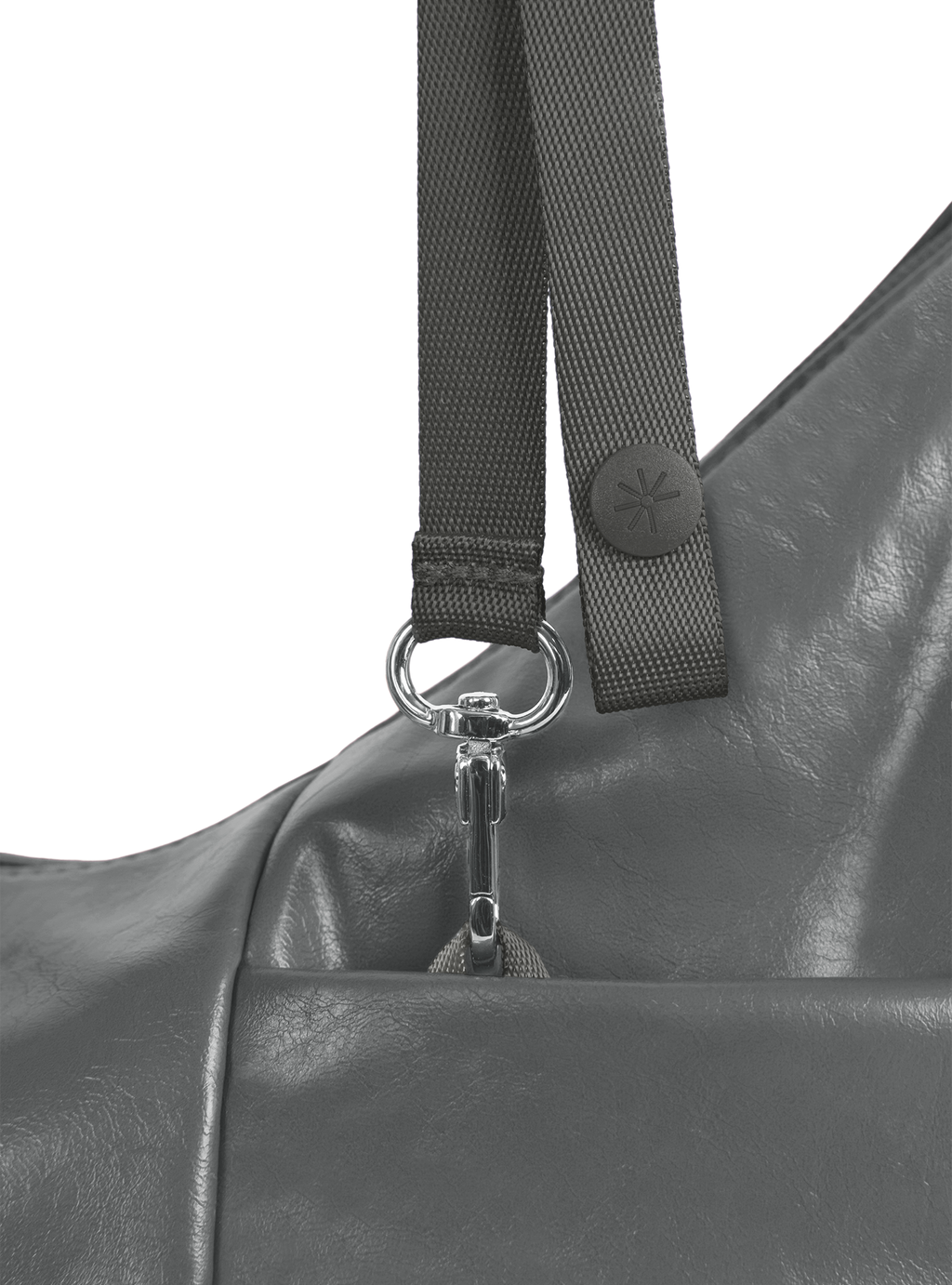 Exterior pocket of the Mini Arc hobo-style shoulder bag in deep grey vegan leather, with concealed snap loop