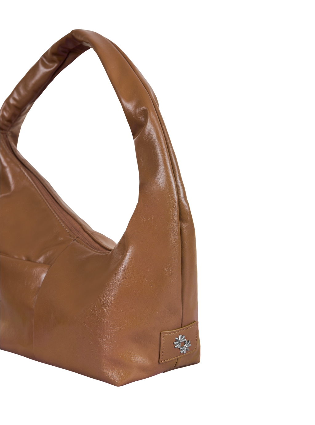 Close-up of the Mini Arc hobo-style shoulder bag in warm brown vegan leather, showing metal logo emblem