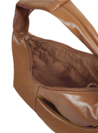 Interior of the Mini Arc hobo-style shoulder bag in warm brown vegan leather, with zipped interior pocket