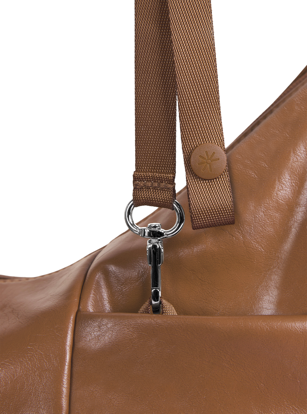 Exterior pocket of the Mini Arc hobo-style shoulder bag in warm brown vegan leather, with concealed snap loop