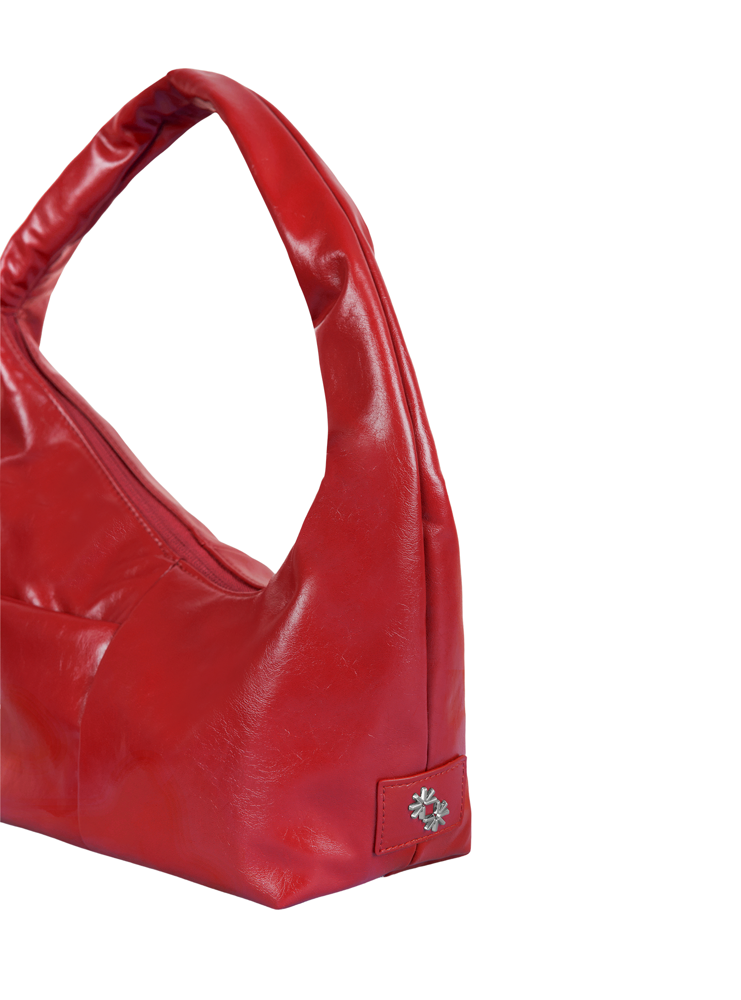 Close-up of the Mini Arc hobo-style shoulder bag in red vegan leather, showing metal logo emblem