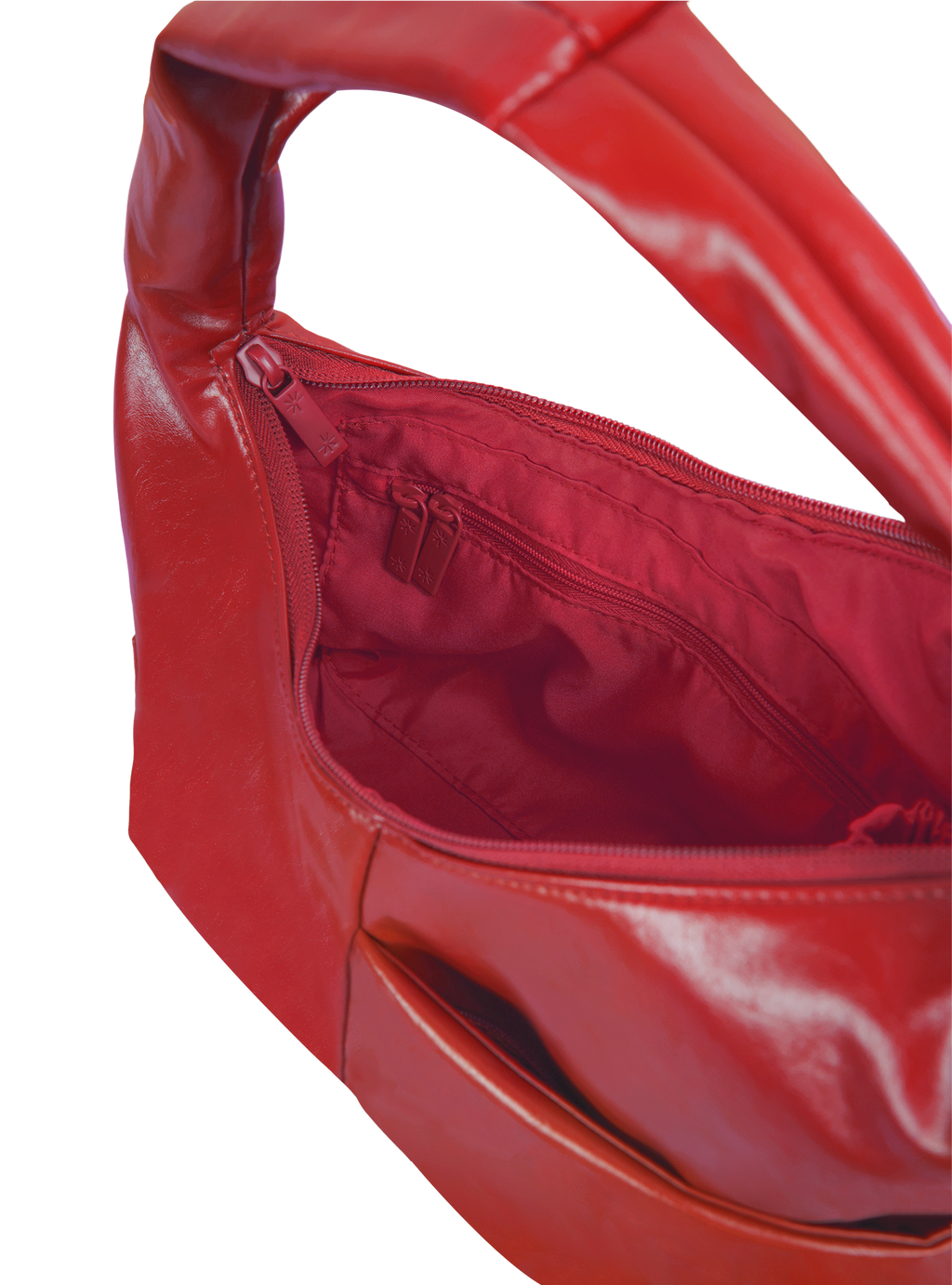 Interior of the Mini Arc hobo-style shoulder bag in red vegan leather, with zipped interior pocket