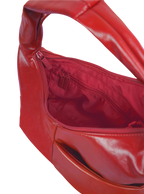 Interior of the Mini Arc hobo-style shoulder bag in red vegan leather, with zipped interior pocket