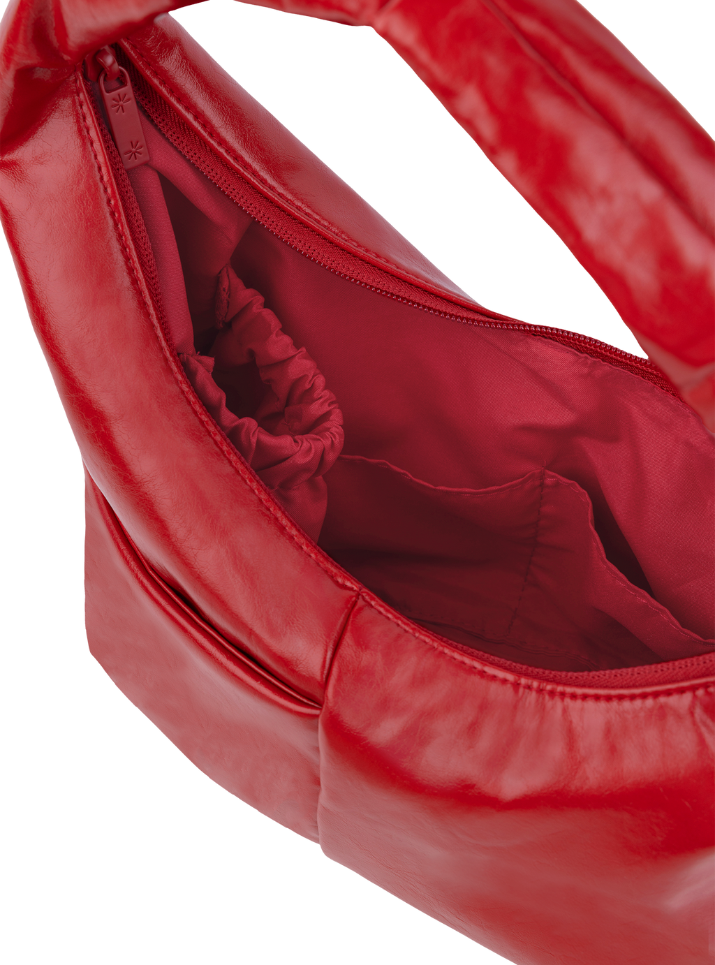 Interior of the Mini Arc hobo-style shoulder bag in red vegan leather, with multiple pockets and a bottle holder
