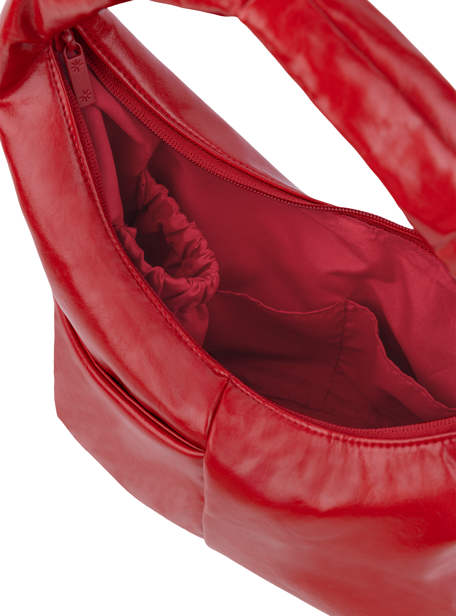 Interior of the Mini Arc hobo-style shoulder bag in red vegan leather, with multiple pockets and a bottle holder