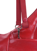 Exterior pocket of the Mini Arc hobo-style shoulder bag in red vegan leather, with concealed snap loop