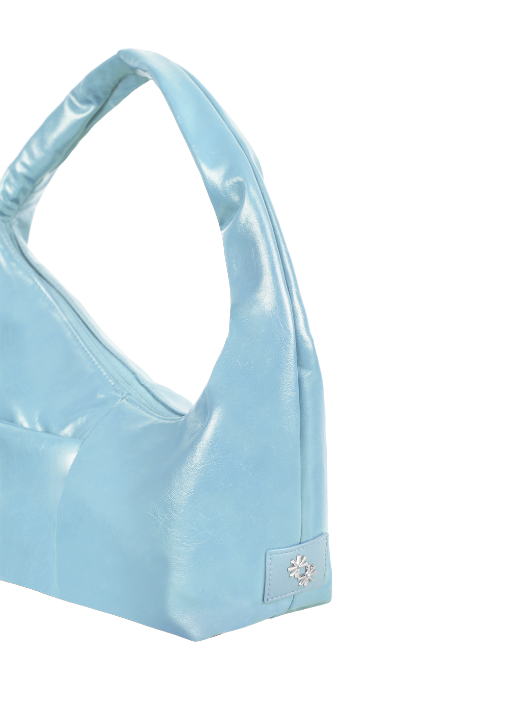 Close-up of the Mini Arc hobo-style shoulder bag in pale blue vegan leather, showing metal logo emblem