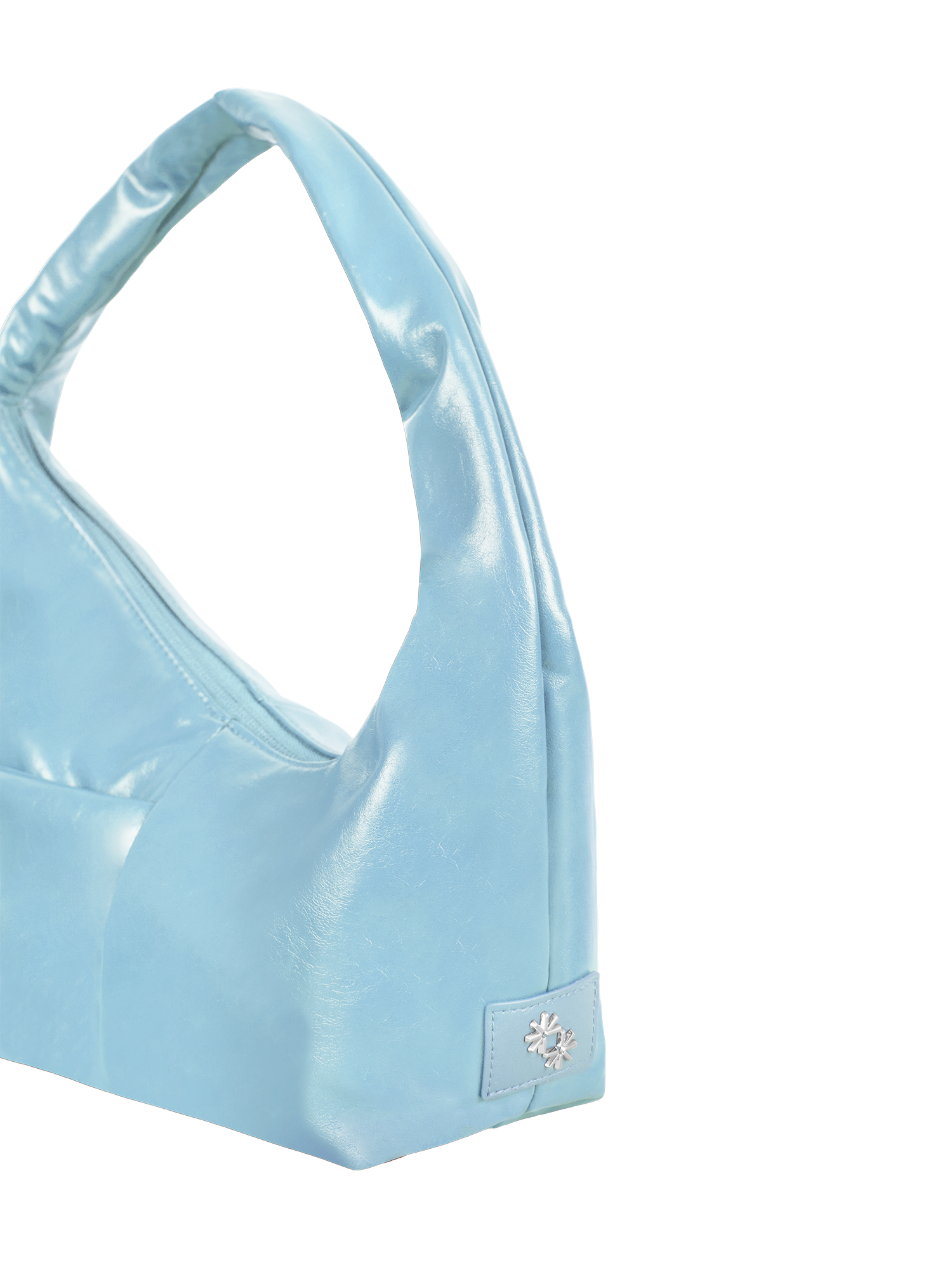 Close-up of the Mini Arc hobo-style shoulder bag in pale blue vegan leather, showing metal logo emblem