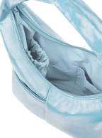 Interior of the Mini Arc hobo-style shoulder bag in pale blue vegan leather, with multiple pockets and a bottle holder