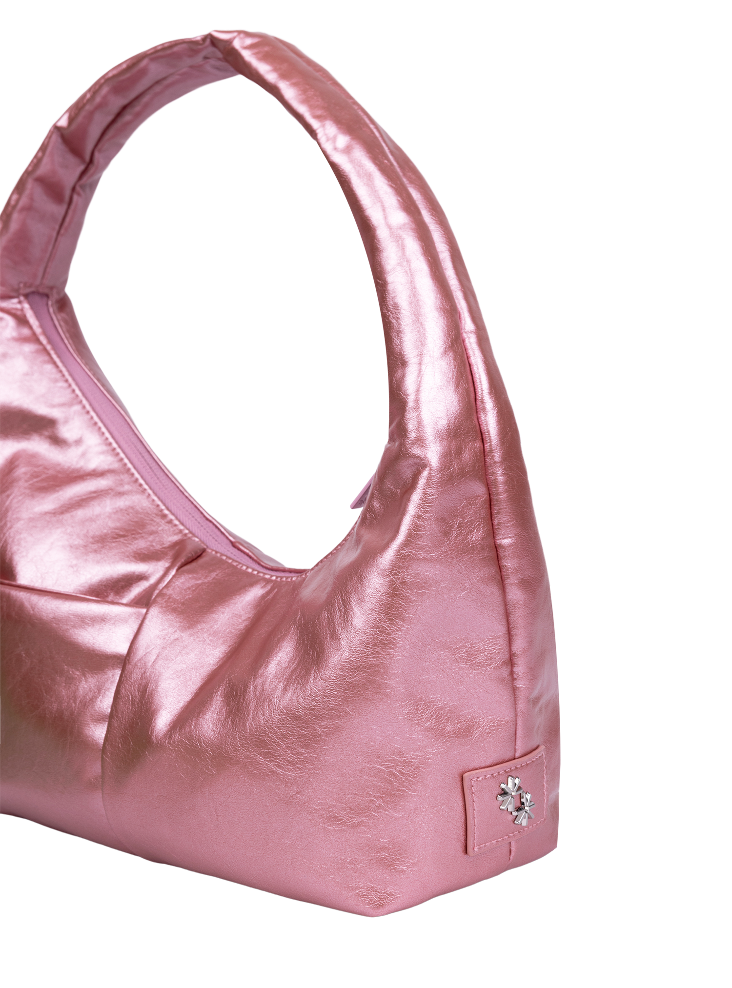 Close-up of the Mini Arc hobo-style shoulder bag in metallic pink vegan leather, showing metal logo emblem
